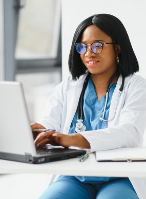 African American doctor working in her office at clinic